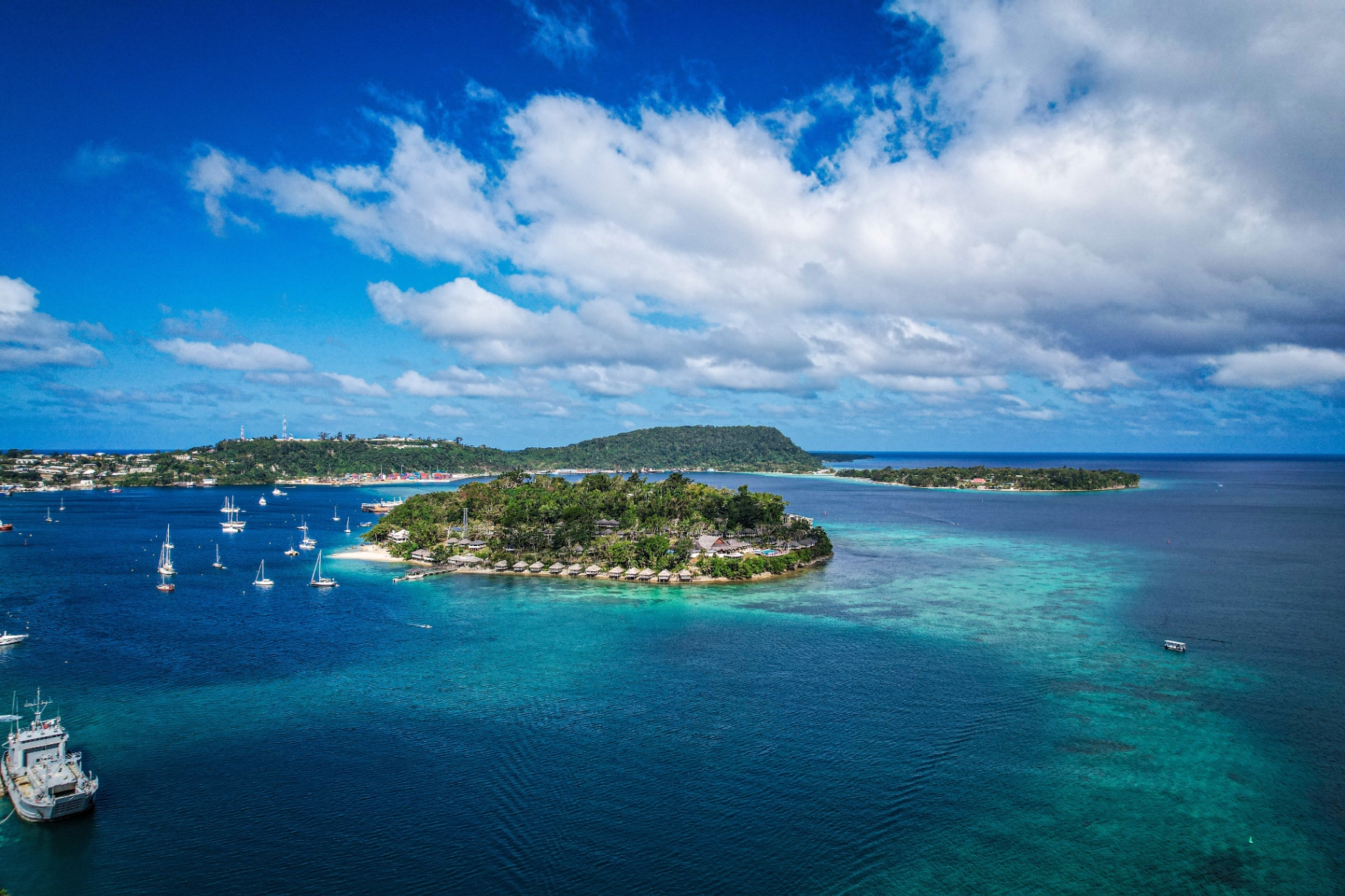 Port Vila harbour at golden hour with luxury yachts